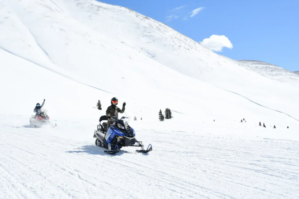 Riders on a family-friendly Prospector guided snowmobile tour at Copper Mountain, Colorado.