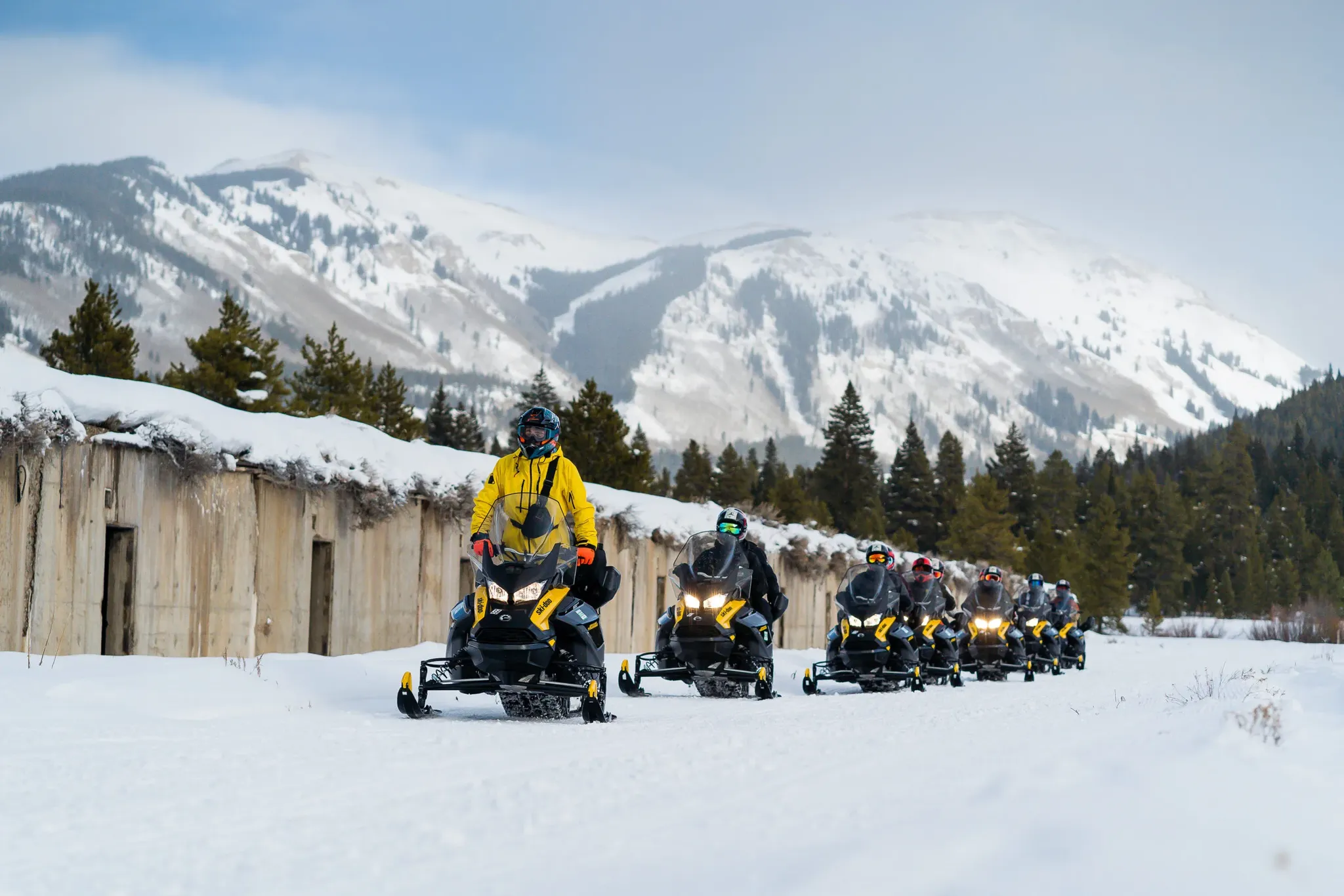 Self-guided snowmobile rental riders on groomed trails at Vail Pass near Copper Mountain and Frisco, Colorado.
